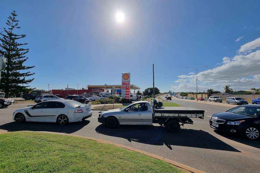 A long line of cars stretches down the road.