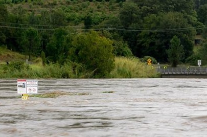 Water level rising underneath a bridge.