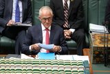 Malcolm Turnbull looks up from papers in Question Time