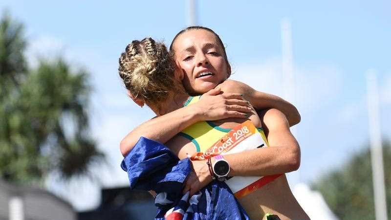 Claire Tallent hugs Jemima Montag of Australia after she crosses the finish line