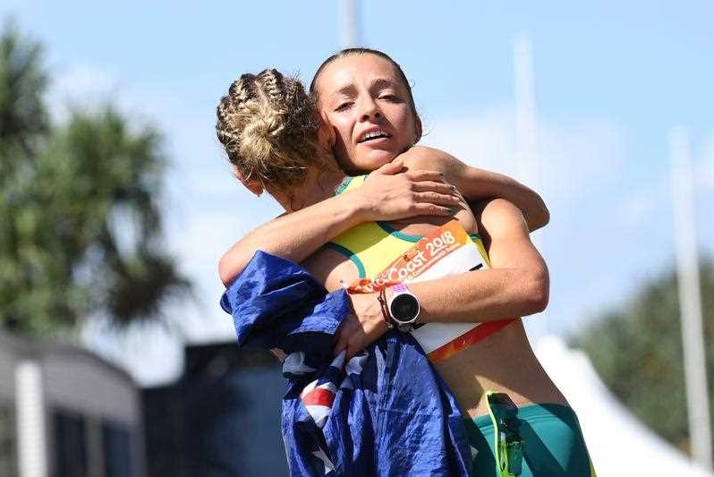 Claire Tallent hugs Jemima Montag of Australia after she crosses the finish line