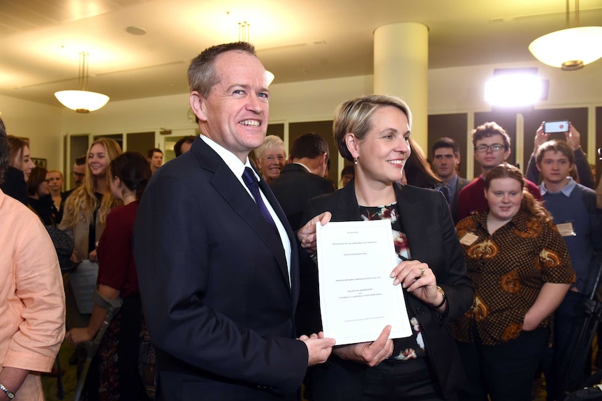 Bill Shorten and Tanya Plibersek hold the Marriage Amendment Bill