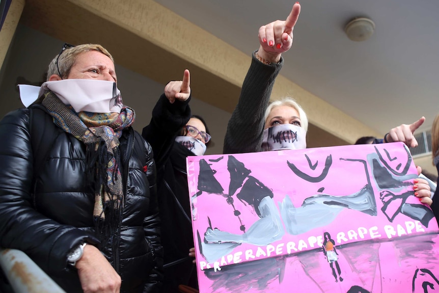 Protesters stage a demonstration outside a court house in Cyprus.