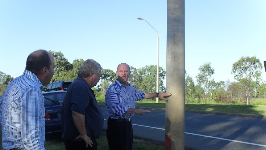 Campbell Newman (far right) discusses Bruce Highway flood level with state candidate Bruce Young and Federal MP Ken O'Dowd.