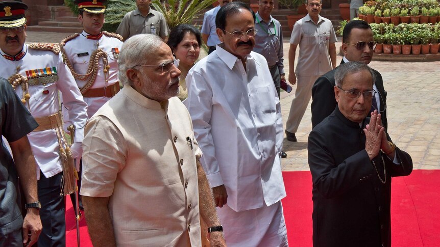 Indian Prime Minster Narendra Modi (L) arrives to address the joint session of Parliament in New Delhi