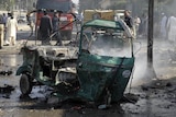 Pakistani security officials and volunteers examine the site of the twin suicide bomb attack in Quetta.