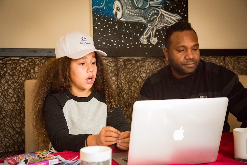 Téa Devow and her father Dion are using video chat on their laptop.