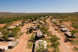An aerial photo of houses and trees in a desert landscape.
