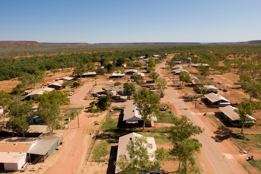 An aerial photo of houses and trees in a desert landscape.