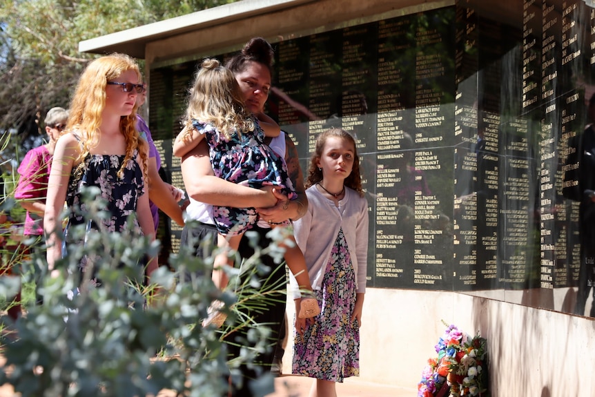 A woman and her three children at a miners memorial service.  