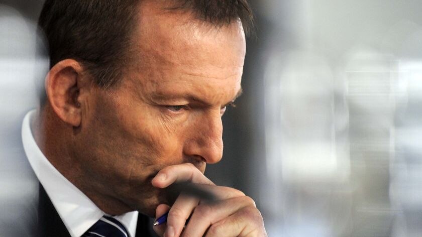 Opposition leader Tony Abbott listens during a debate