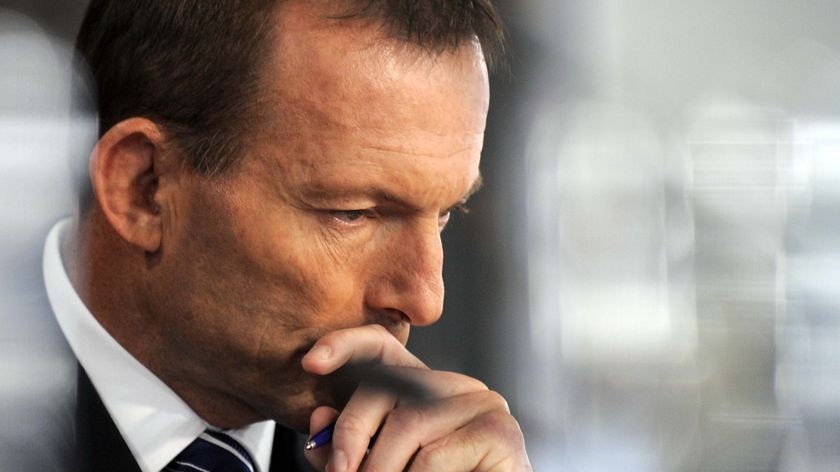 Opposition leader Tony Abbott listens during the health debate (AAP: Alan Porritt, file photo)