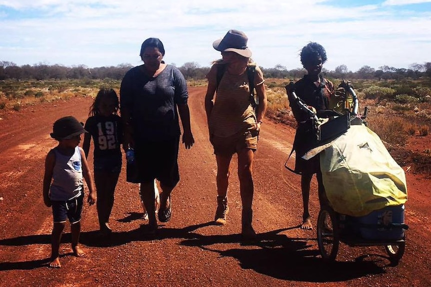 A photo of Ms Cole walking with Molly's daughter Maria and her family.