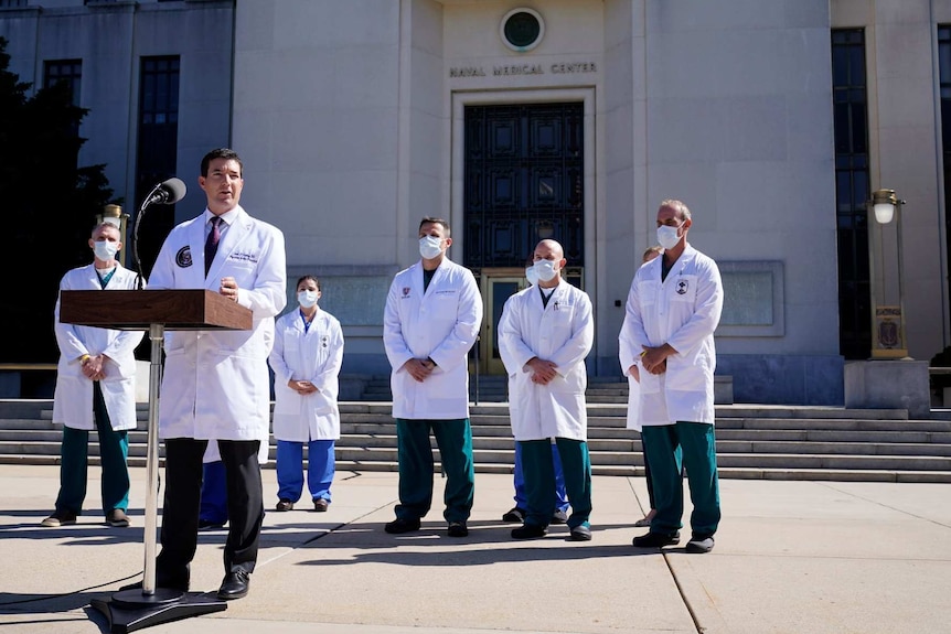 Donald Trump's doctor Sean Conley speaks at a microphone set up outside Walter Reed National Military Medical Center