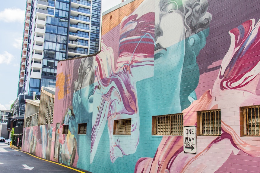 Large street art on a side of a building in South Brisbane by artist Mimi.