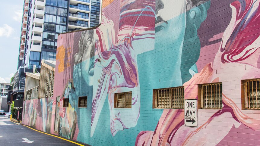 Large street art on a side of a building in South Brisbane by artist Mimi.