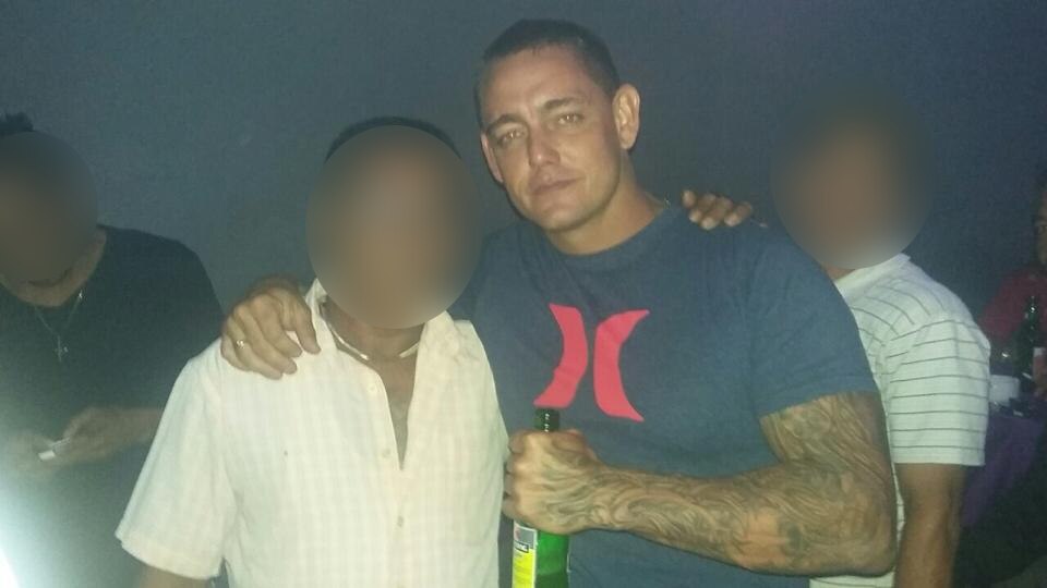 Peter Wellman James holding a drink.