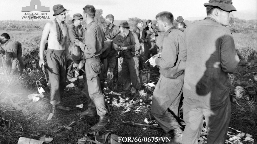 Delta Company eat  rations on a landing zone before returning to the battlefield