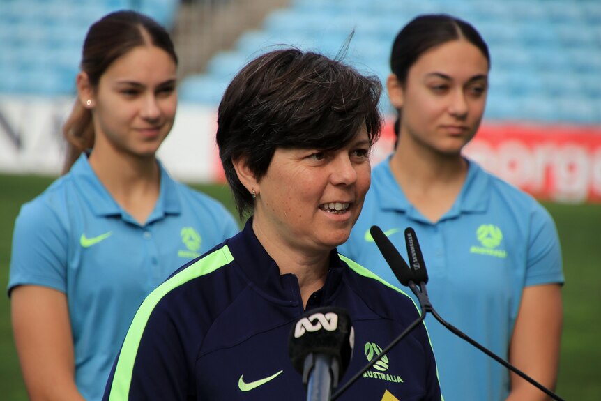 Debbie Fisher talks at a press conference at WIN Stadium wearing a dark blue t-shirt.
