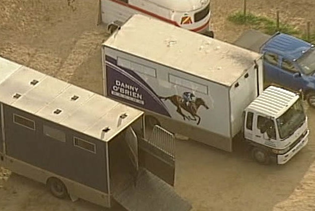 A sign on the side of a large truck that says Danny O'Brien racing.