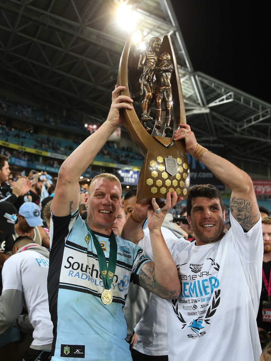 Luke Lewis (L) with Michael Ennis after Cronulla won its maiden premiership in 2016.