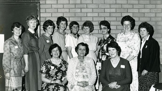A black and white image of 12 nurses taken in 1981