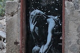 An image of a goddess holding her head in her hand thought to be a Banksy