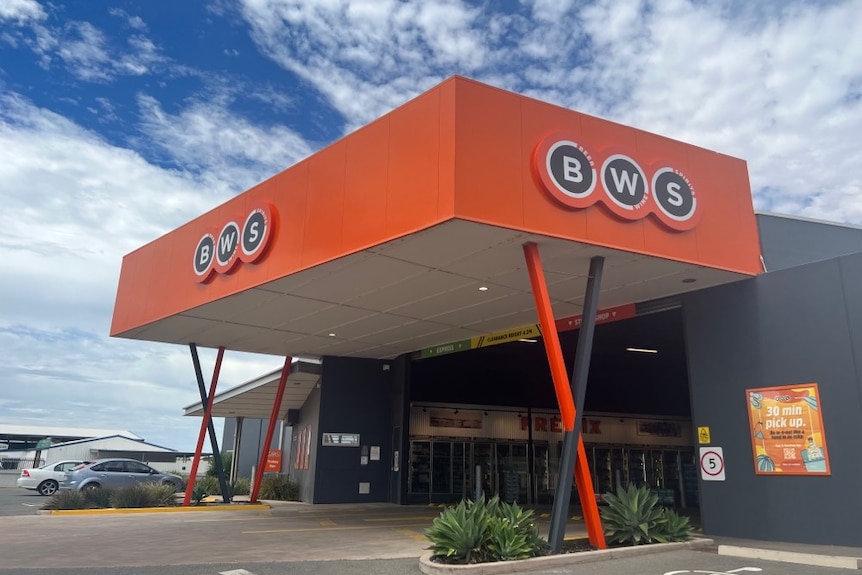 The exterior of a large bottle shop emblazoned with orange "BWS" signage