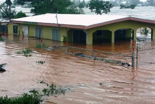 Floodwaters flow through a house in Rakiraki