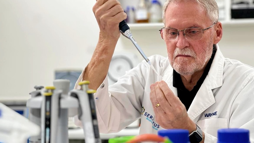 Scientist holding dripper in lab coat