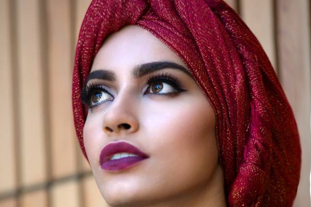 A model wearing a glamorous red hijab.