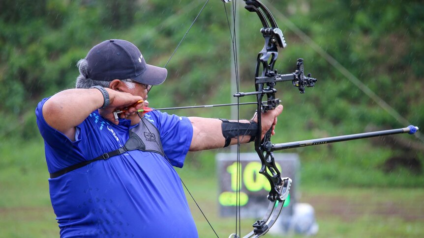 Samoa's PM Tuilaepa Sailele competing in archery at the Pacific Games