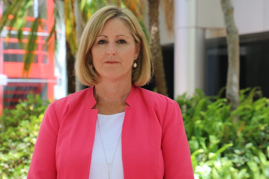 A mid shot of Department of Education director general Sharyn O'Neill standing outside with a pink jacket on.
