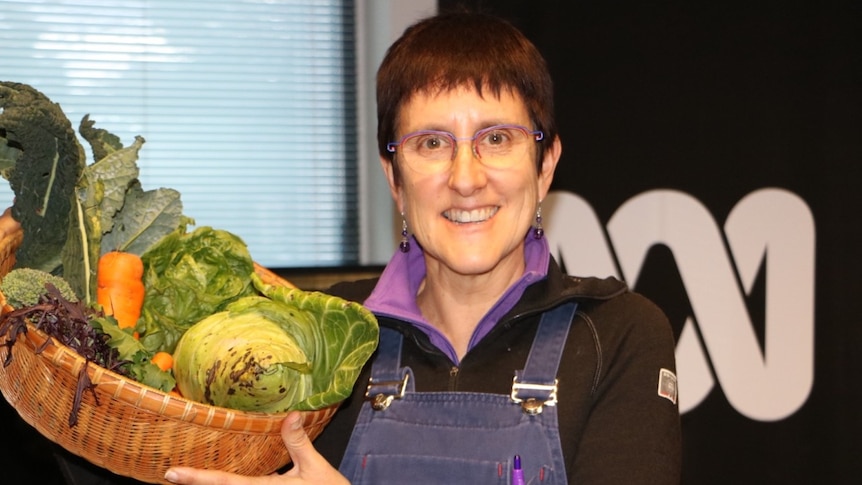 Image of Fiona Buining from Ainslie Urban Farm holding basket of fresh vegetables.