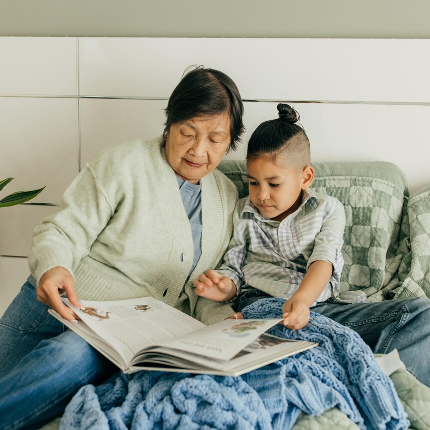 Grandparents reading with grandson