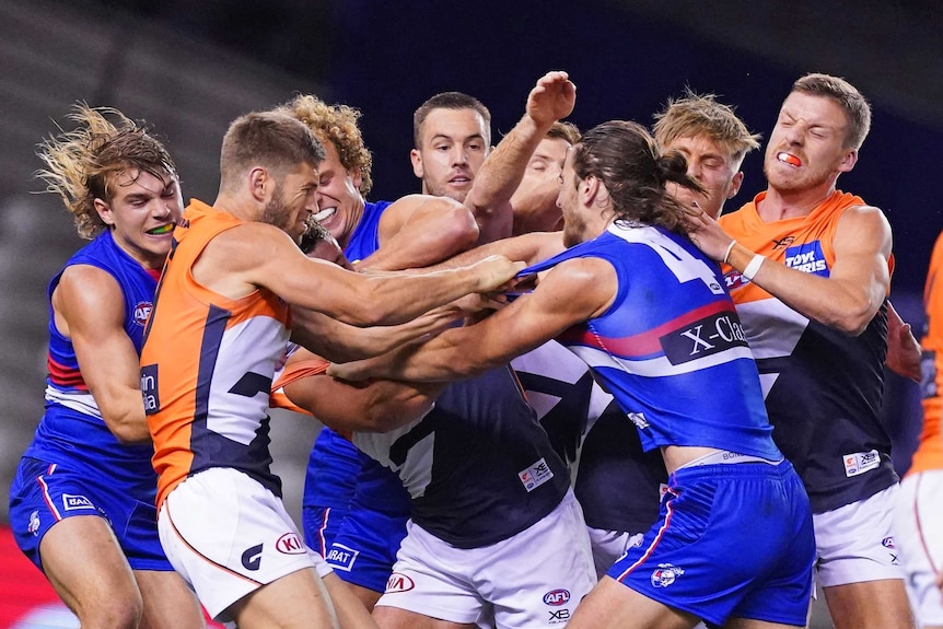 Western Bulldogs and Giants AFL players involved in a melee on the field.