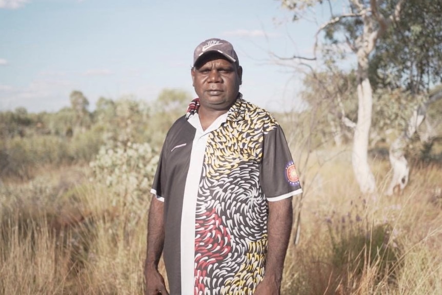 An Aboriginal man standing in the bush