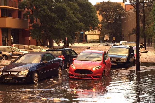 Water swamps the streets and submerges cars in Alexandria, Sydney on April 25, 2015