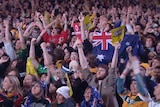 Fans in Federation Square cheer as Australia scores