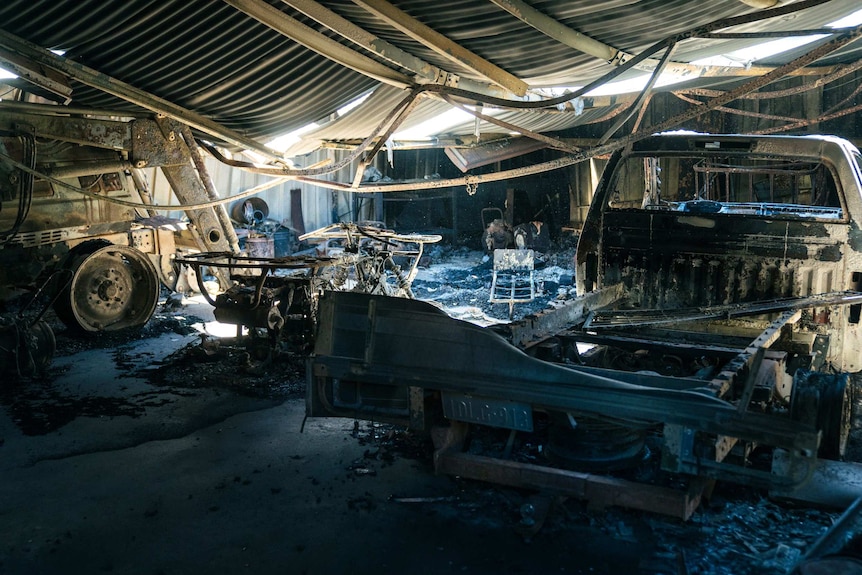 The twisted remains of a shed after fire swept through it.