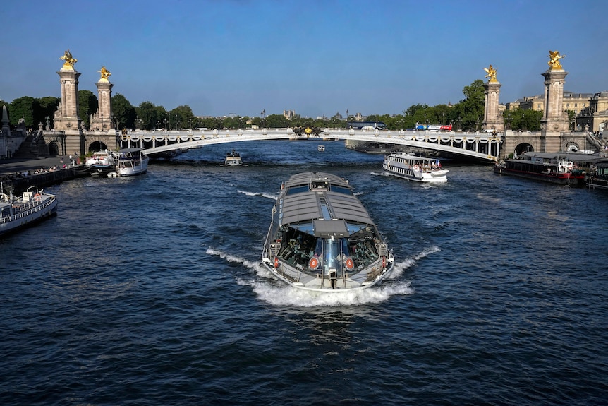 A barge cruises past the Alexandre III bridge is photographed in Paris, Thursday, June 1, 2023.