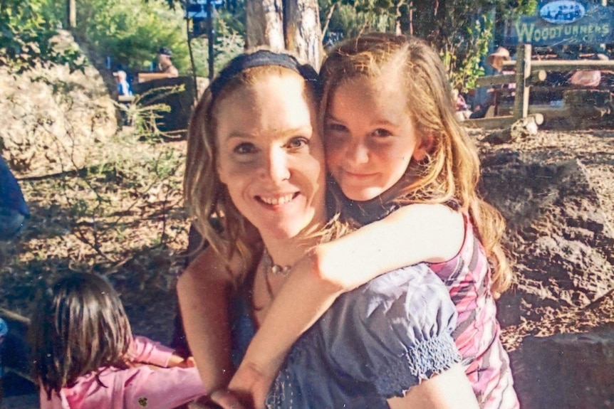 A mother and her daughter wait in line at dreamworld