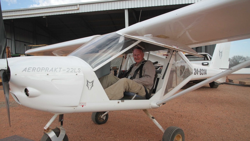 Doug Harrison sitting in his white light aircraft smiling ready for take off