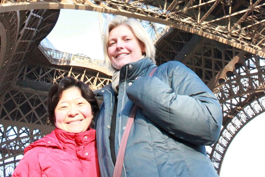 ACO violinists Helena Rathbone and Aiko Goto pose under the Eiffel Tower.