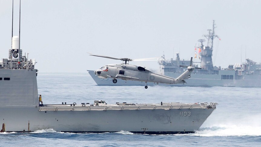 A Taiwan Navy S70 helicopter takes off from a frigate during a navy exercise off Taiwan.