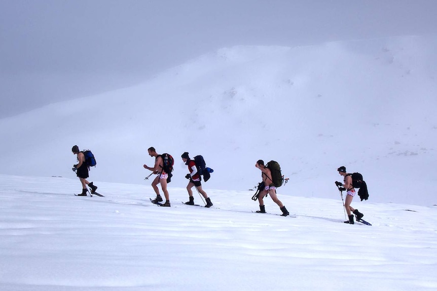 Side view of five men trekking on Mt Kosciuszko