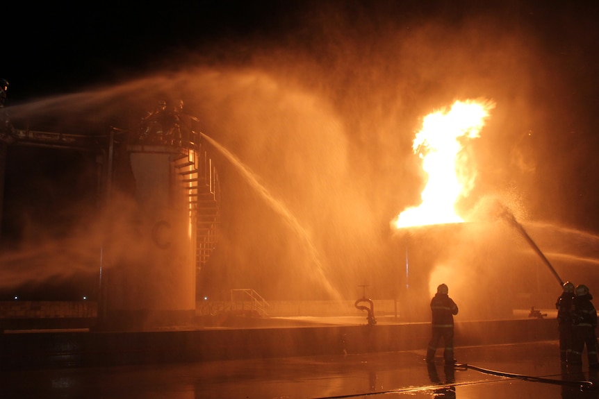 A firefighter tackles a large orange blaze alone