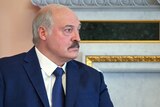 Alexander Lukashenko sits in profile at a meeting with Russian president Putin in St Petersburg