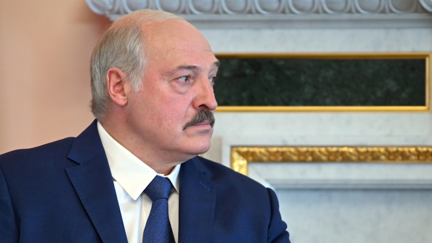 Alexander Lukashenko sits in profile at a meeting with Russian president Putin in St Petersburg