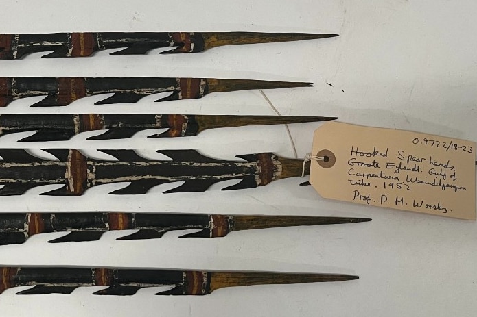 Six pointed spears on a table with a tag identifying where they are from